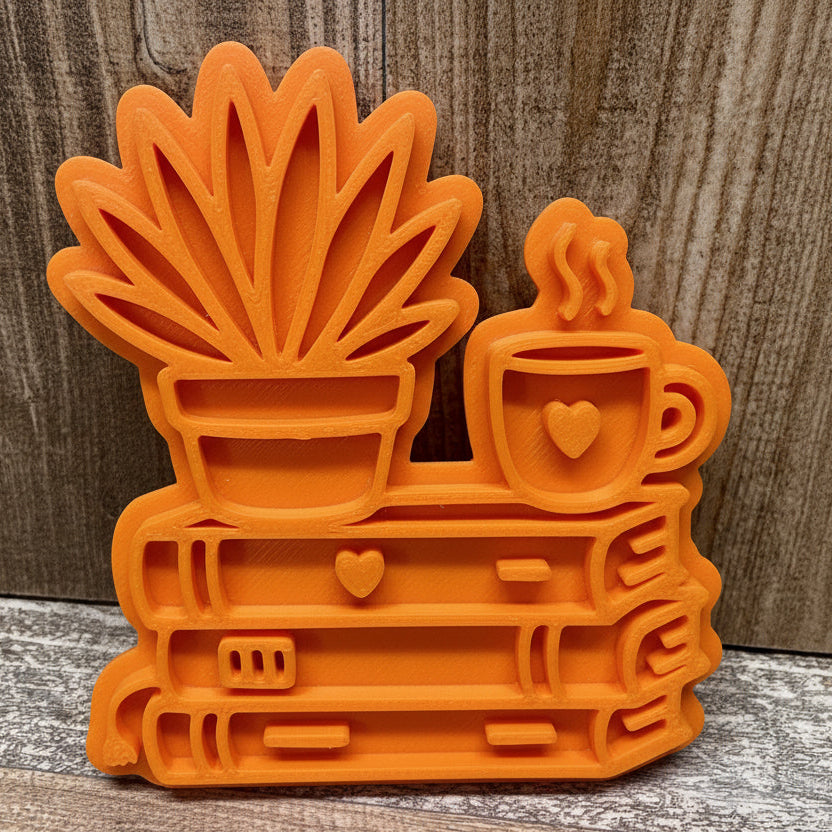 Bücherstapel mit Aloe & Kaffee-/Teetasse